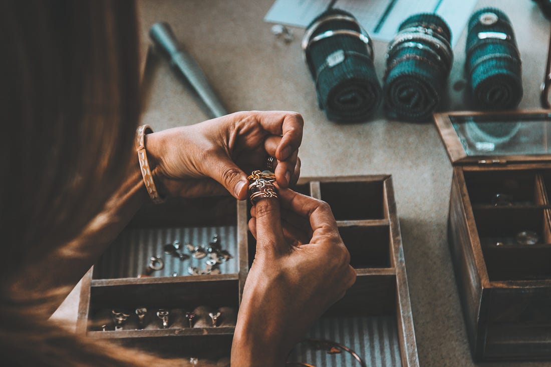 black woman’s hands making jewellery for article by Larry G. Maguire