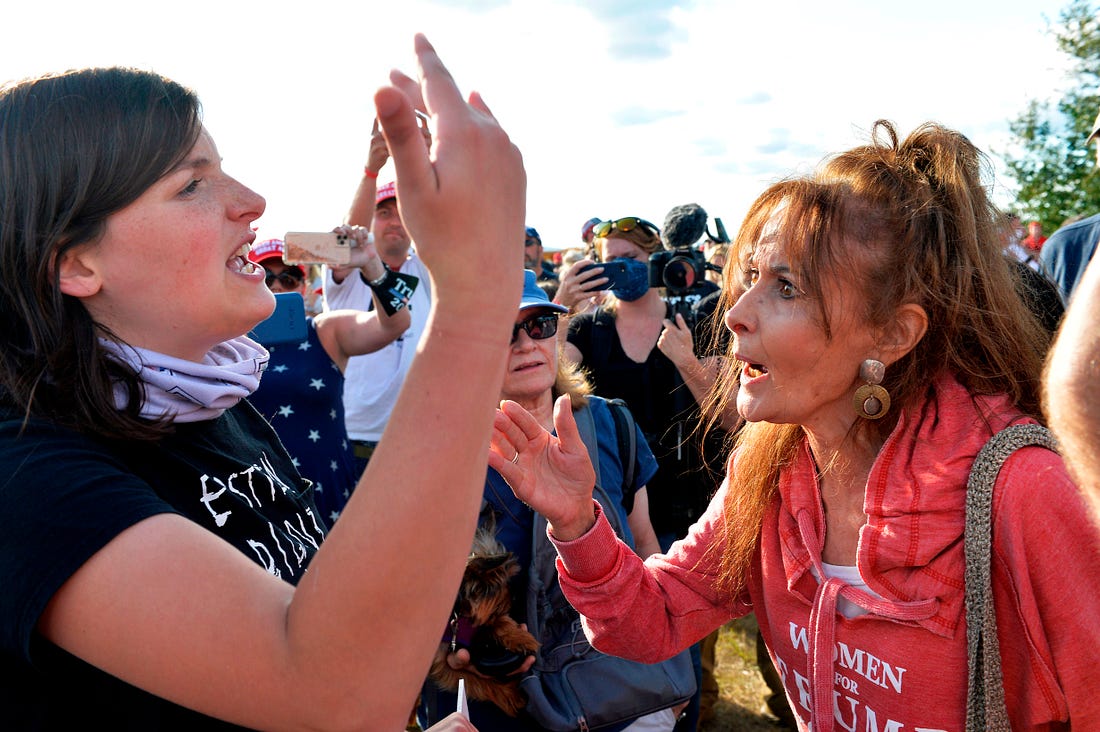 Anti Trump protesters and supporters face off in arguments and scuffles during a Campaign Rally, the day after the end of the Republican National Convention, at Manchester airport in Londonderry, New Hampshire on August 28, 2020. (Photo by Joseph Prezioso / AFP) (Photo by JOSEPH PREZIOSO/AFP via Getty Images)