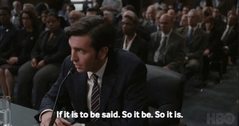 Cousin Greg from Succession, wearing a suit and tie and testifying before a Congressional committee, saying "If it is to be said. So it be. So it is."