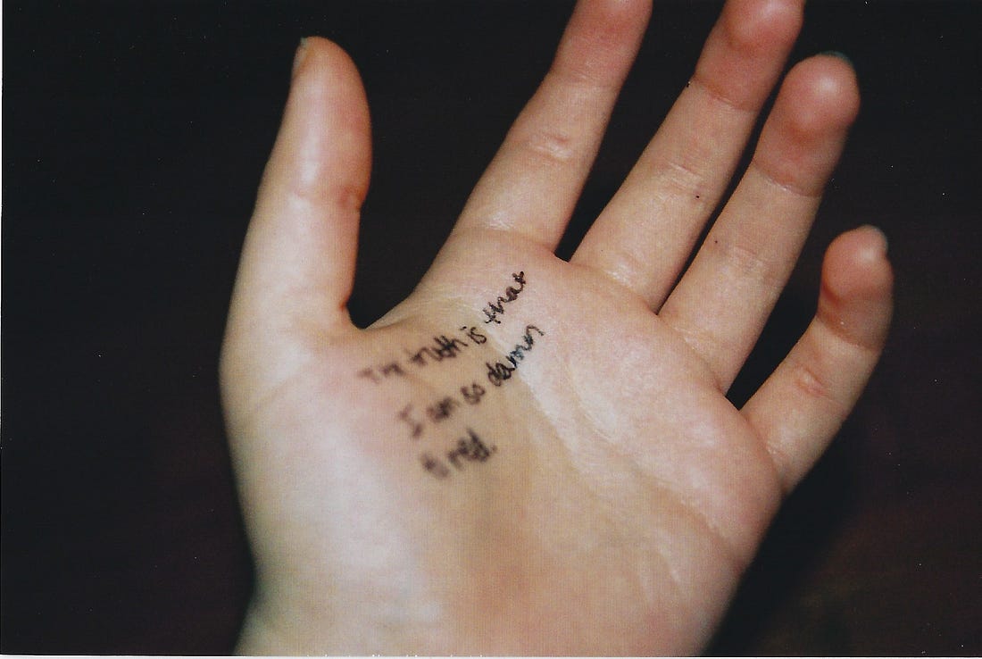 Hand on which is written: "The truth is that I am so damn tired." Hand on which is written: "The truth is that I am so damn tired."