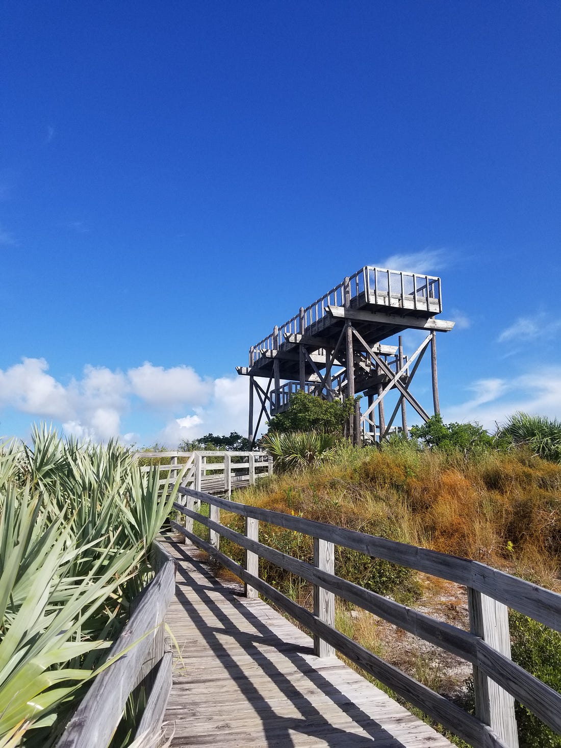 a wooden lookout tower against a clear blue sky