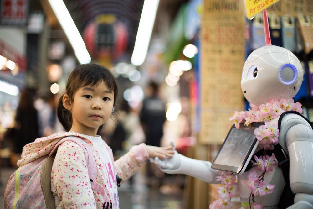 photo of girl laying left hand on white digital robot