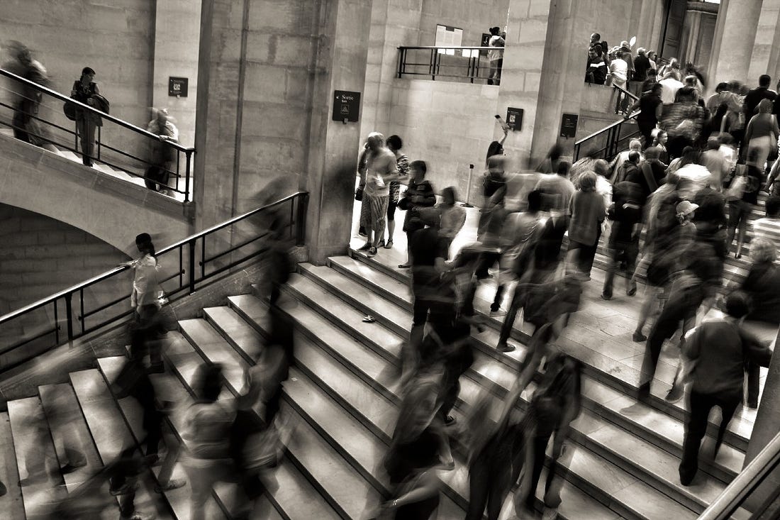 black and white image of a crowd climbing stairs on article by Larry G. Maguire