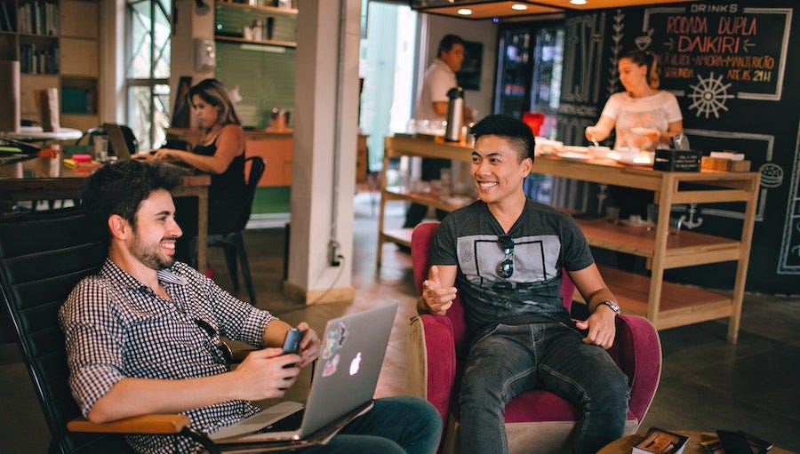 Coworking space with two men talking Coworking space with two men talking