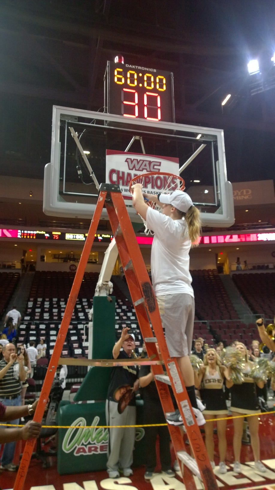 Stacey Barr cutting down the net after winning the 2014 WAC Tournament - Courtesy University of Idaho