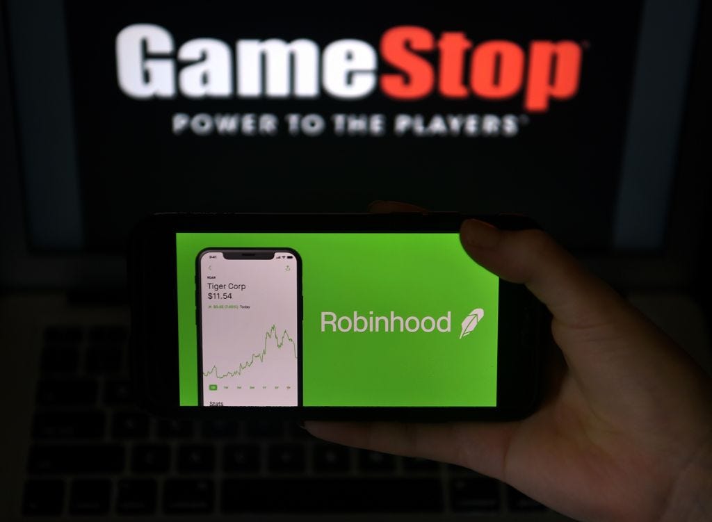 Photo illustration of GameStop and Robinhood. (Olivier Douliery / AFP)