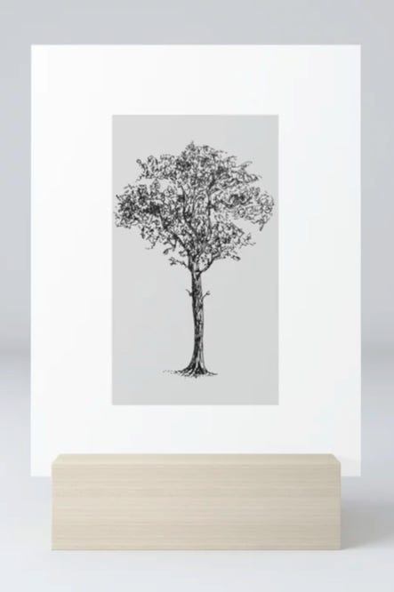 photo of Strong and Rooted art on a mini art print with wooden stand. A hand-drawn pen illustration of a tree on a white card.