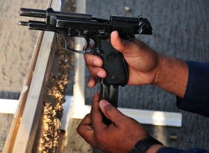 Shooter reloading, slide locked back Shooter reloading, slide locked back