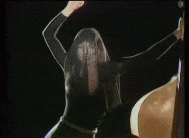 Kate Bush mimes beating a cello [gif]
