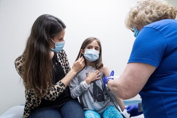 A child receives a second dose of the Pfizer coronavirus vaccine during a clinical trial earlier this year.