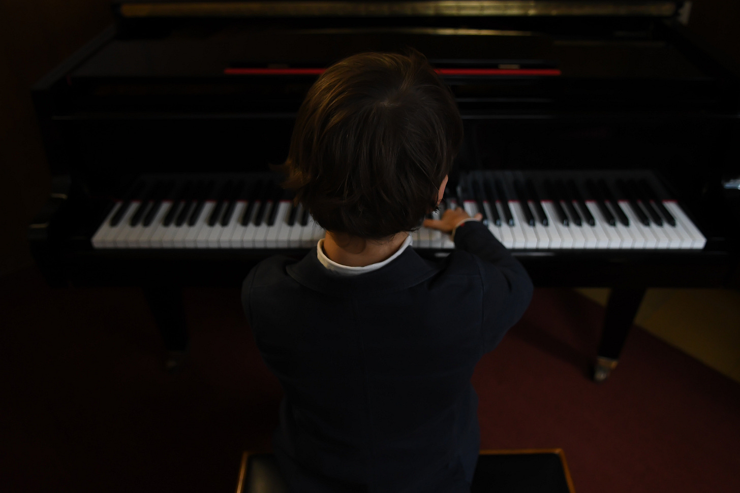 kid playing piano