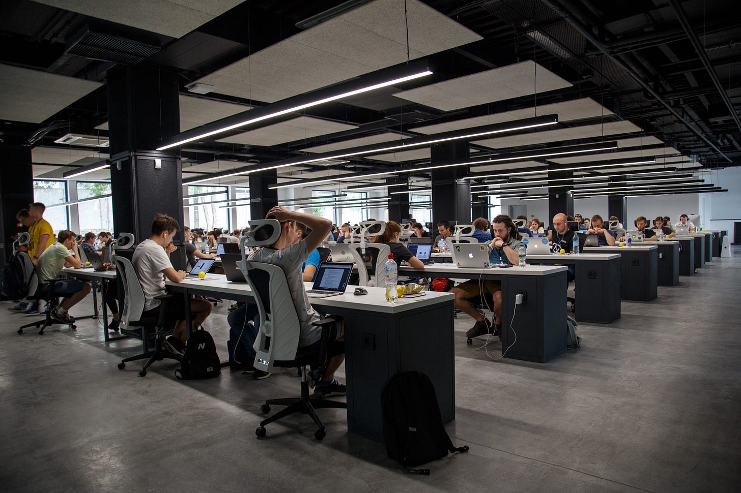 Image of people at work in an office for article titled “motivation to work in contemporary society”. Image of people at work in an office for article titled “motivation to work in contemporary society”.