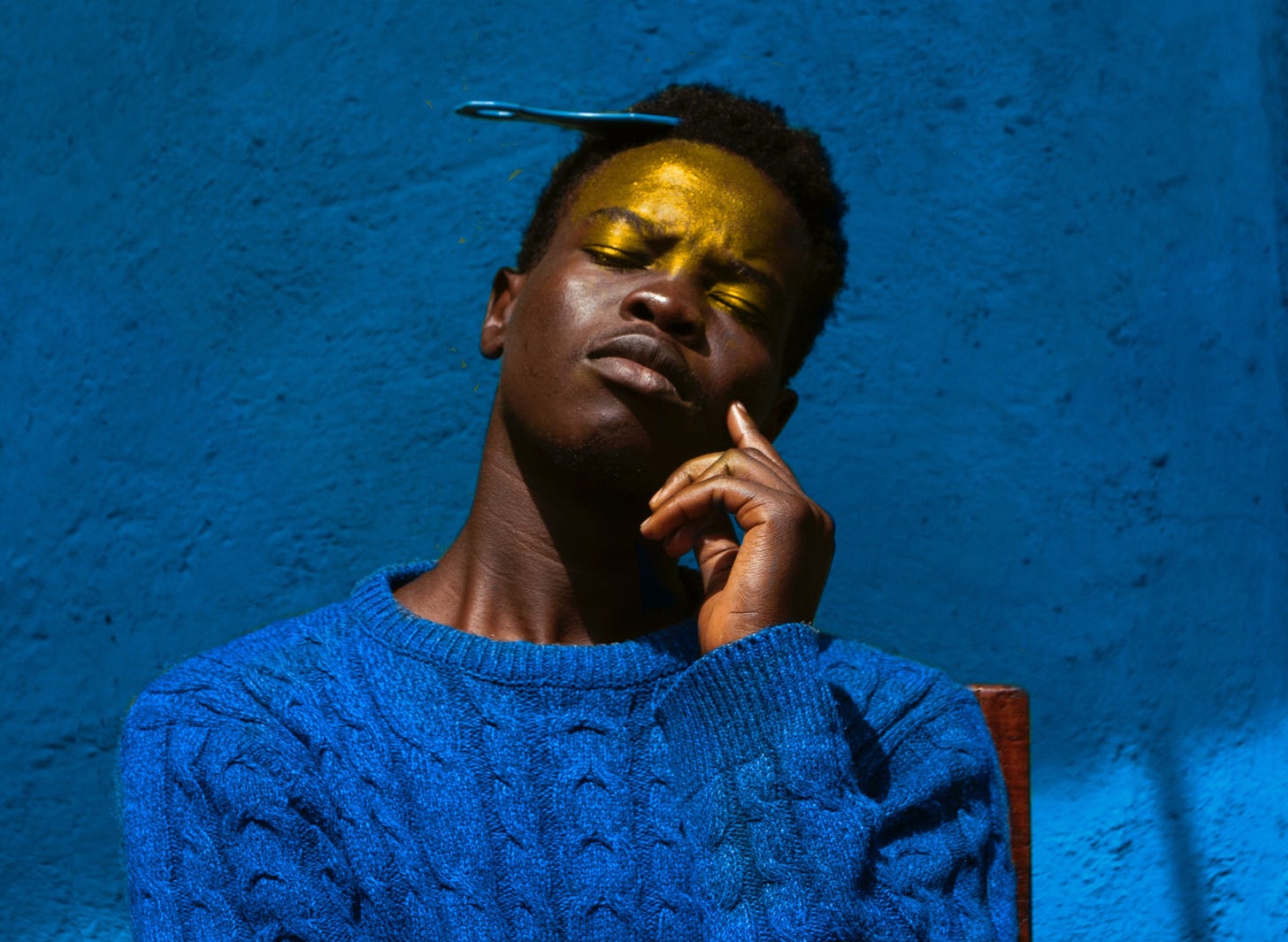 Man in Blue Knit Sweater Against Blue Wall Man in Blue Knit Sweater Against Blue Wall