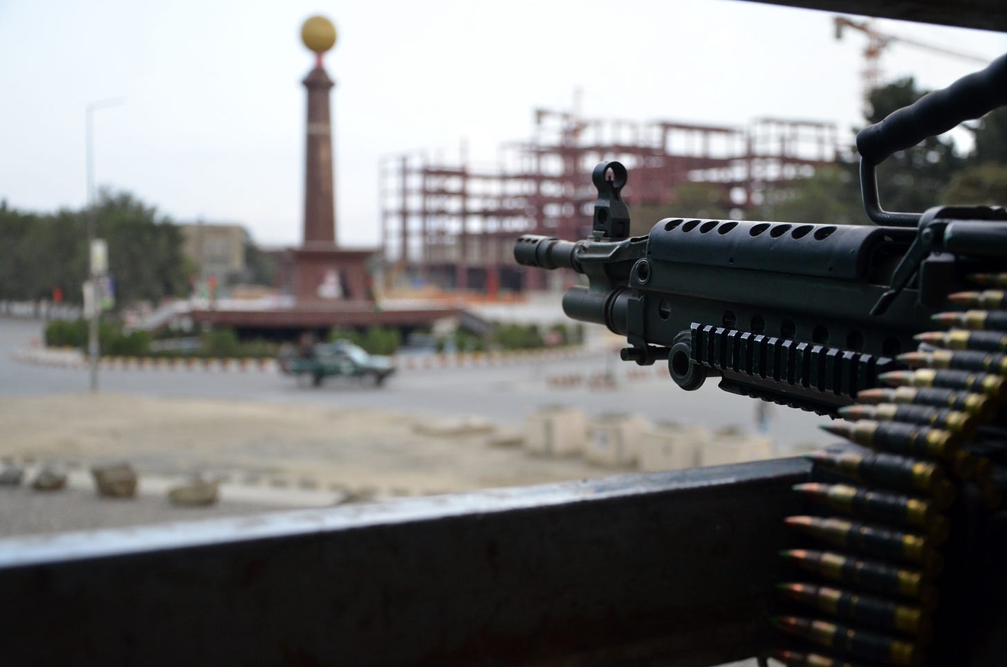 An American machine gubn points at a truck in a traffic circle in Kabul in 2011. An American machine gubn points at a truck in a traffic circle in Kabul in 2011.