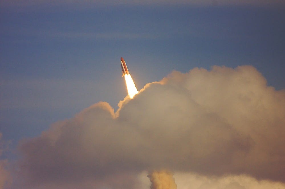 low-angle photography of red space shuttle low-angle photography of red space shuttle
