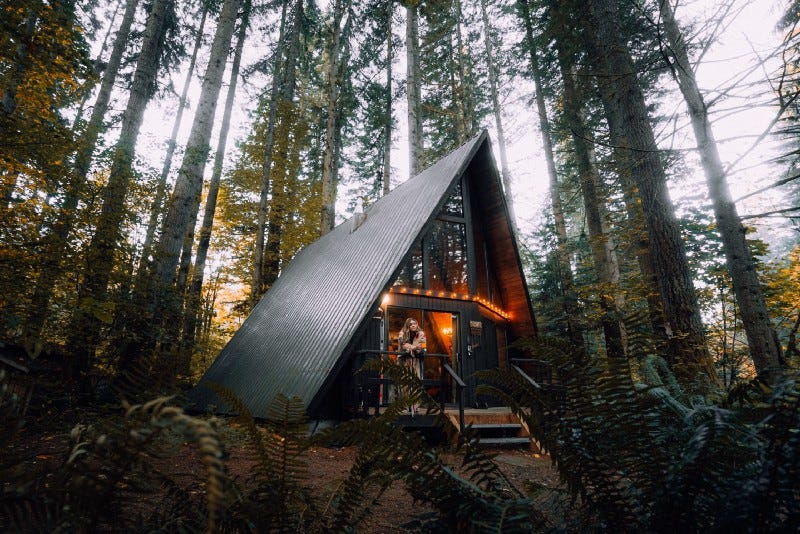 An A-frame cabin in the woods An A-frame cabin in the woods