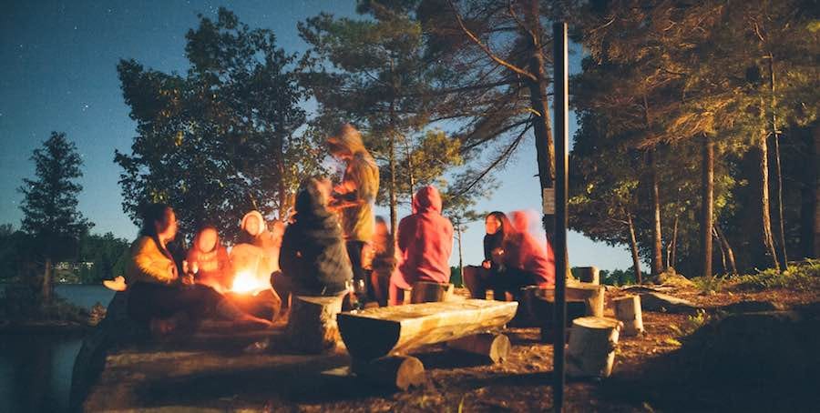 Group sitting around campfire Group sitting around campfire