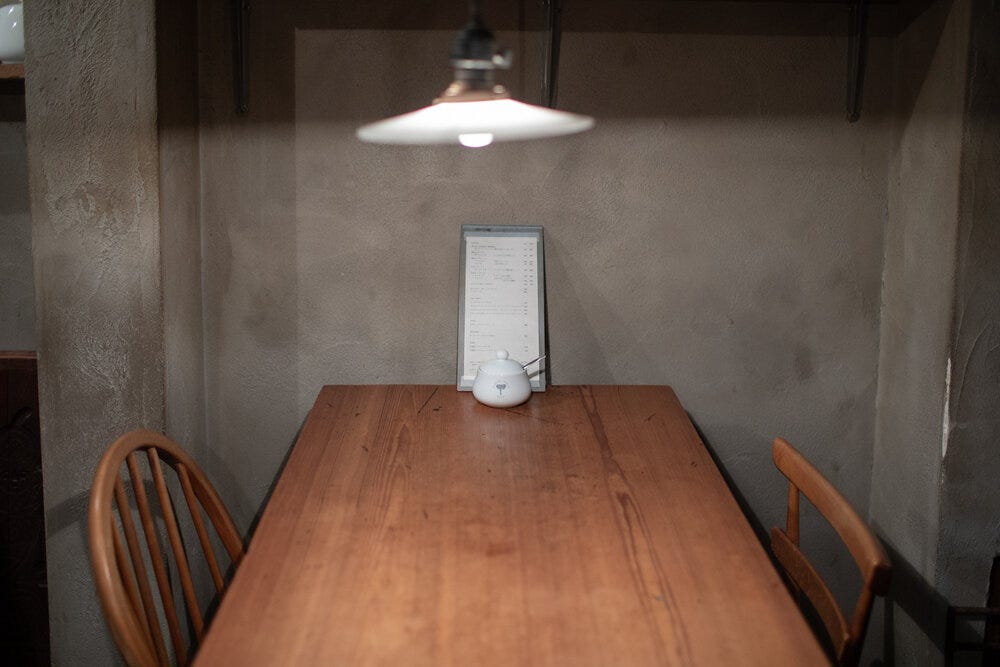 A simple aesthetic at Elephant Factory: wooden tables and chairs, a one page menu, and bare-bones walls. A simple aesthetic at Elephant Factory: wooden tables and chairs, a one page menu, and bare-bones walls.