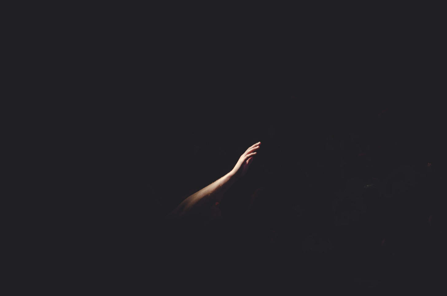 arm reaching out in darkness