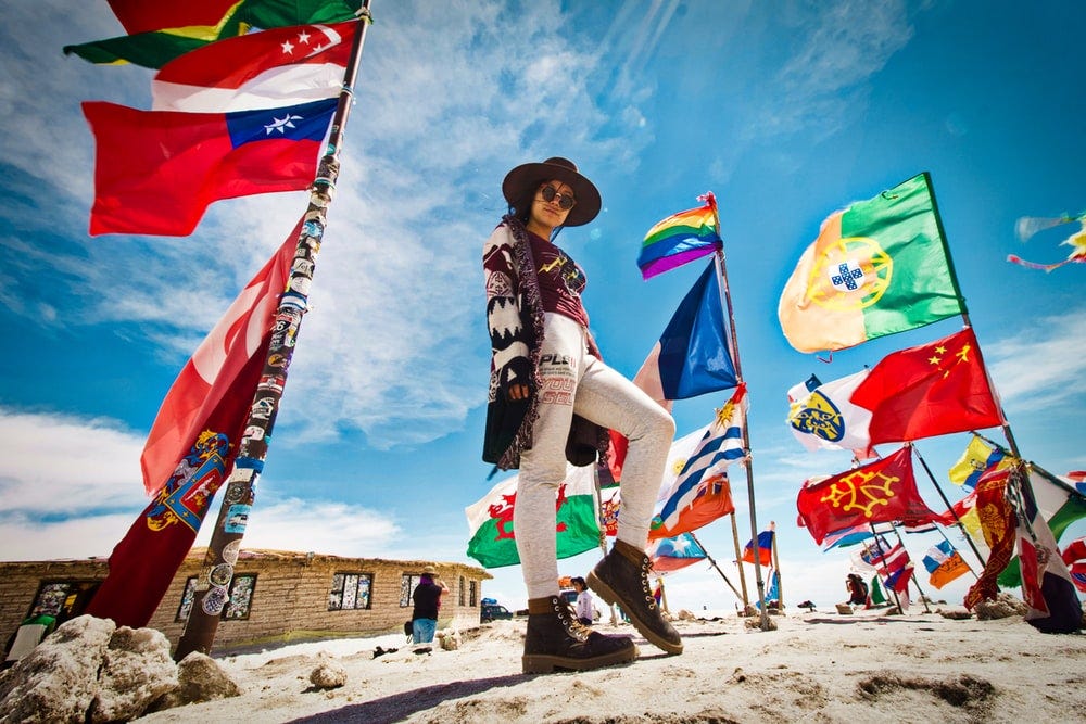 woman standing near flags woman standing near flags