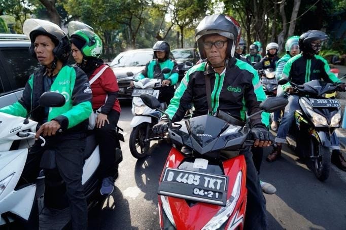 A group of people riding on the back of a motorcycle
Description automatically generated