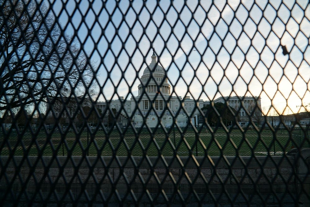 black metal fence near building during daytime black metal fence near building during daytime