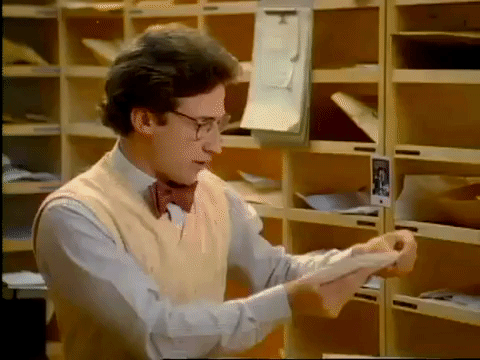 A GIF of a man sorting out letters