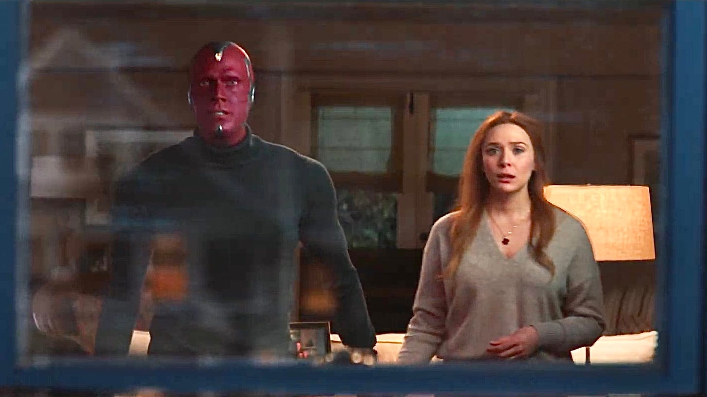 Vision and Wanda standing at a window