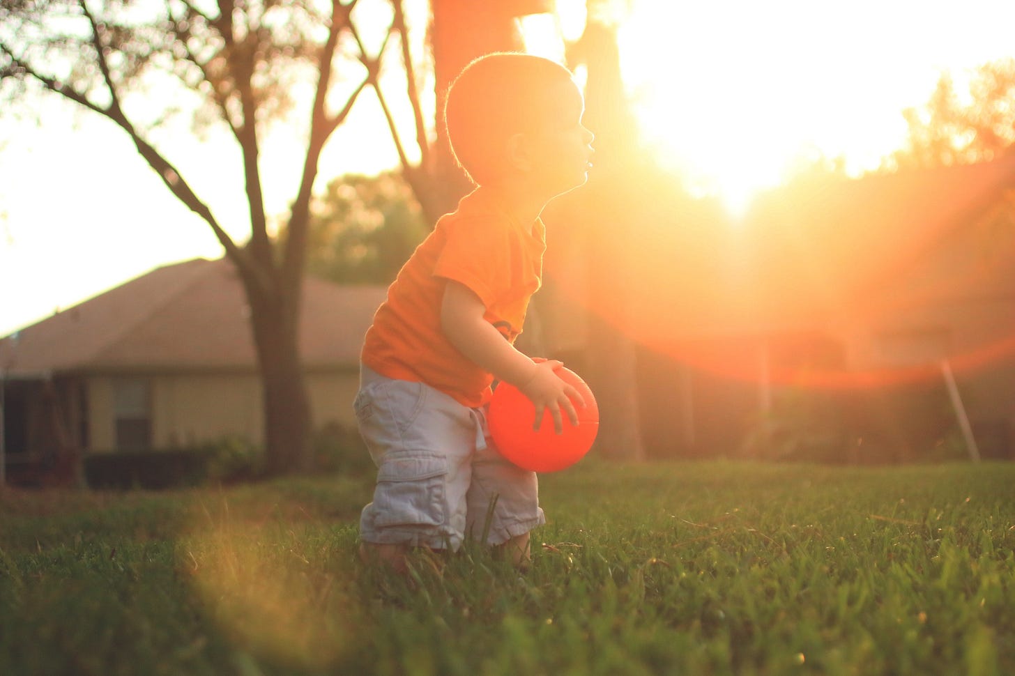 young boy playing ball in the yard for article by Larry G. Maguire young boy playing ball in the yard for article by Larry G. Maguire