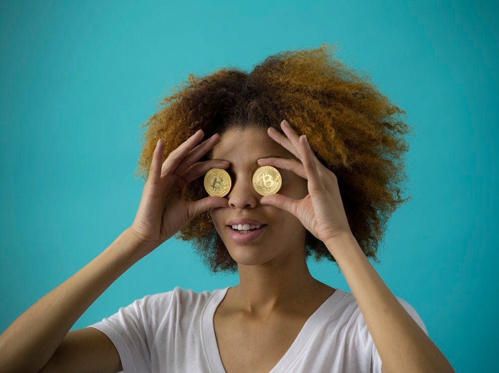 woman holding two round gold-colored coins woman holding two round gold-colored coins