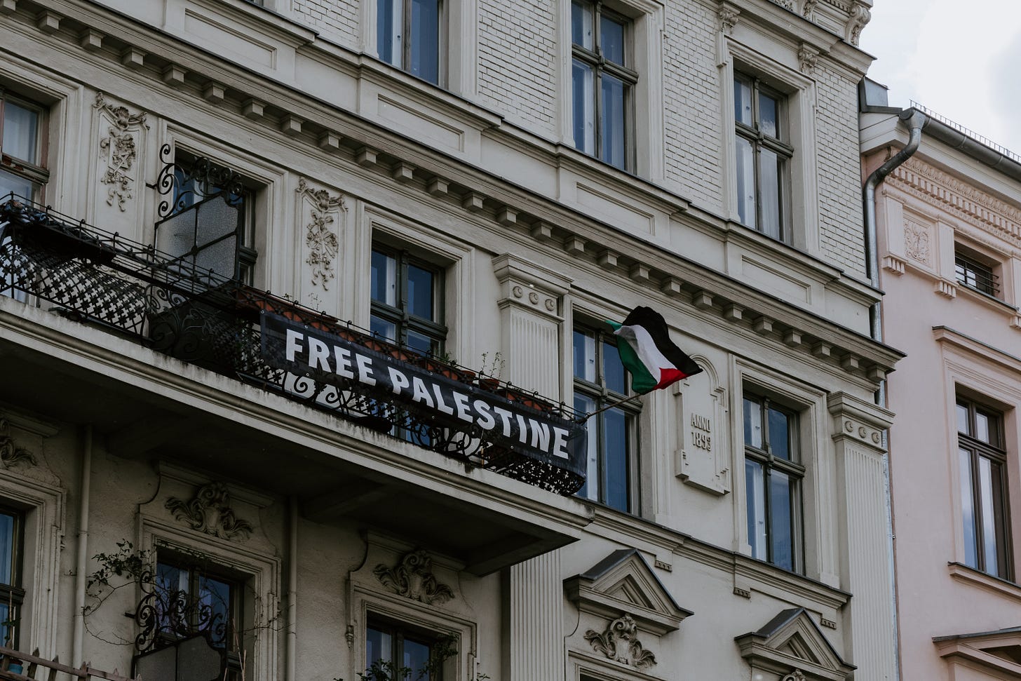 A “Free Palestine” banner hangs on a balcony. A “Free Palestine” banner hangs on a balcony.