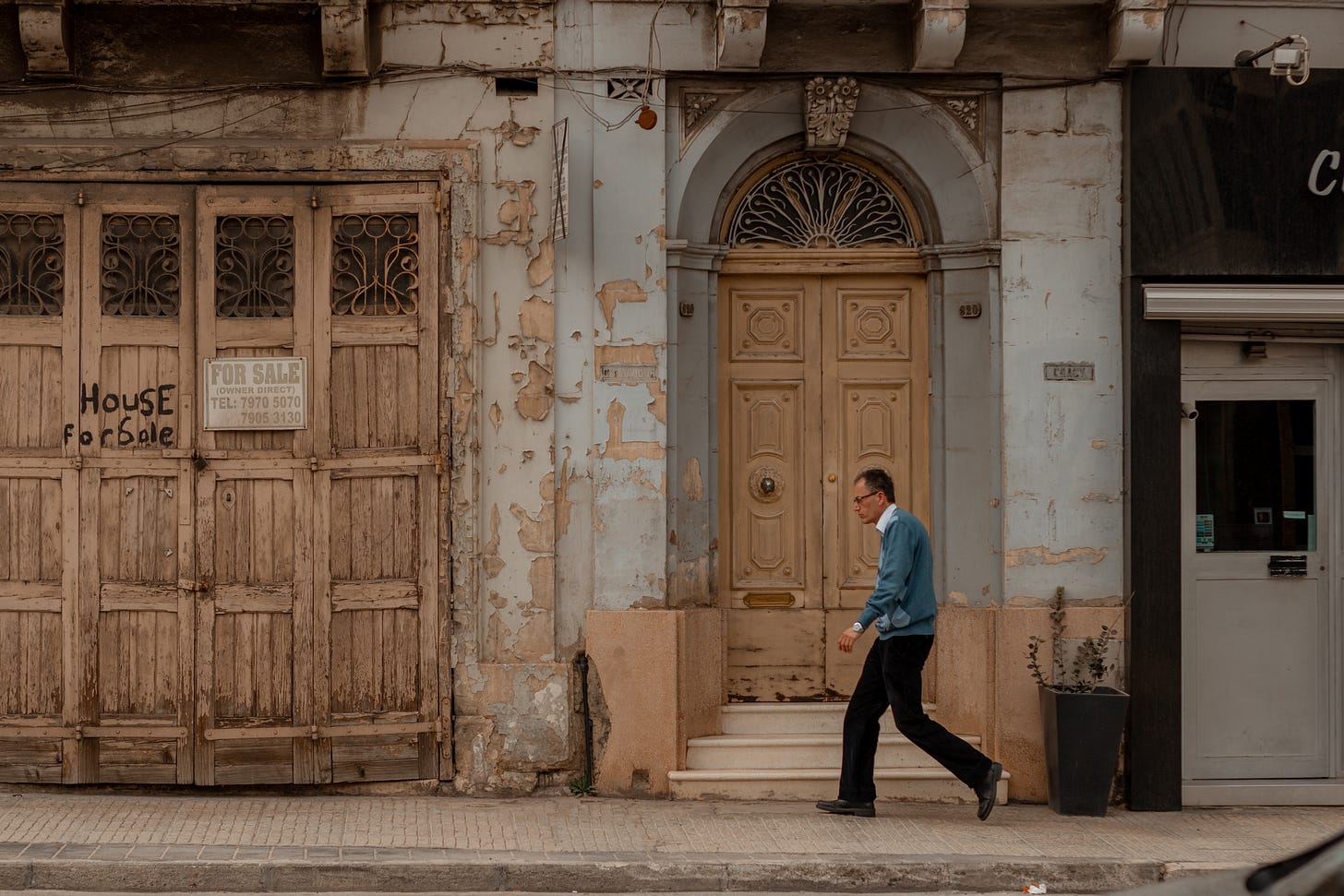 A man walking on the sidewalk in Malta: A photo by David Elikwu