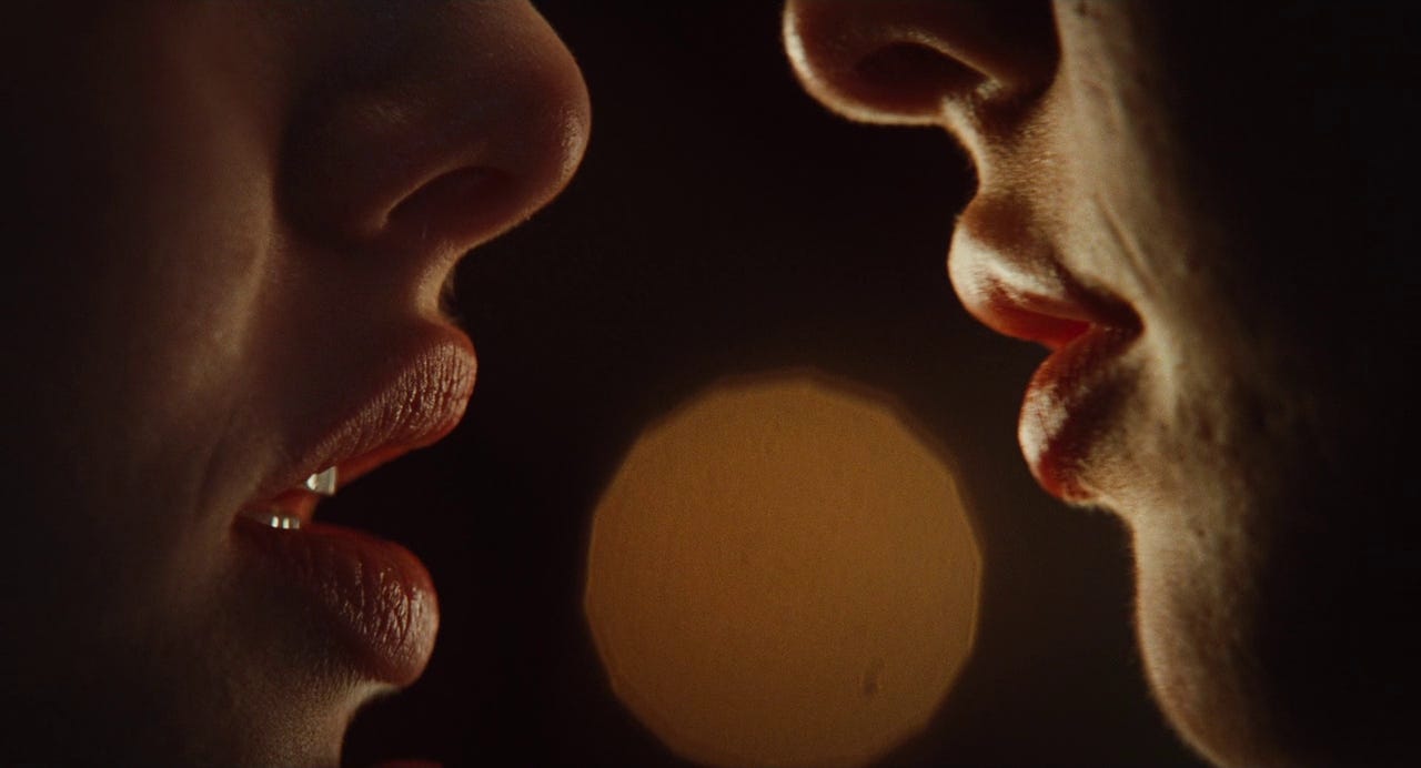 Close-up on Jennifer and Needy's mouths as they are about to kiss