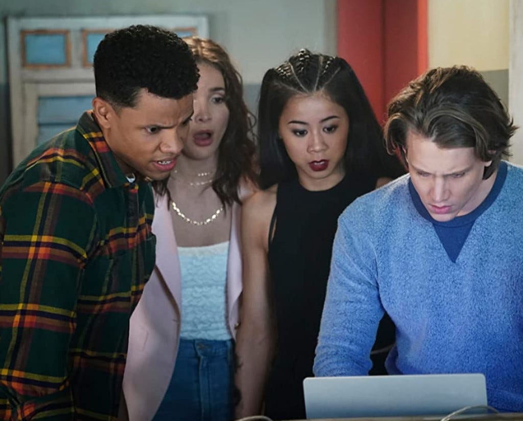 Ace hacks into a computer while Nick, George, and Bess look on