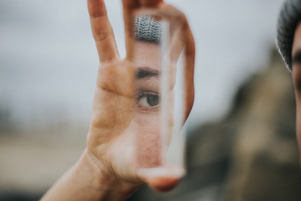 shallow focus of person holding mirror shallow focus of person holding mirror