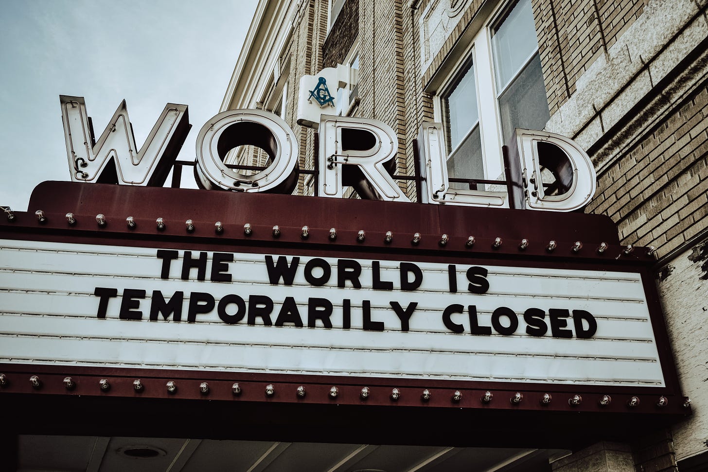 A theater marquee for the World with text: The world is temporarily closed.