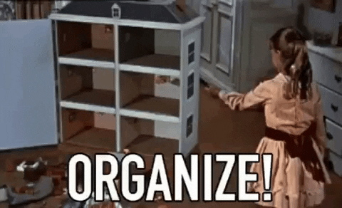 A girl cleans up her toys and says, "Organize!" [gif]