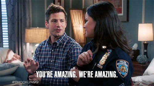 Jake Peralta and Amy Santiago from Brooklyn 99 on a bed with Jake saying "you're amazing, we're amazing!"