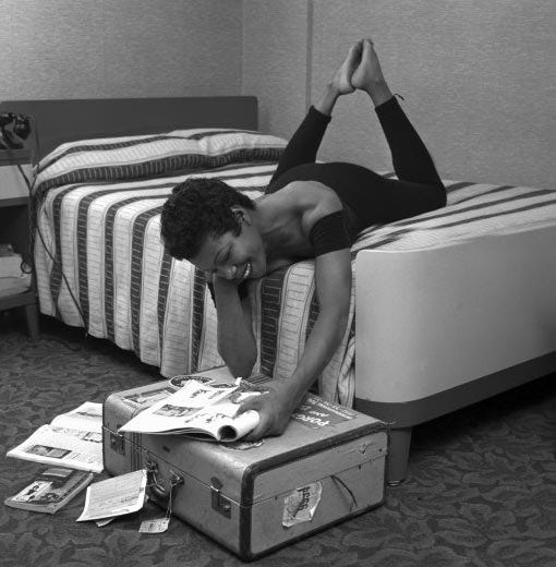 Maya Angelou reading in bed, smiling