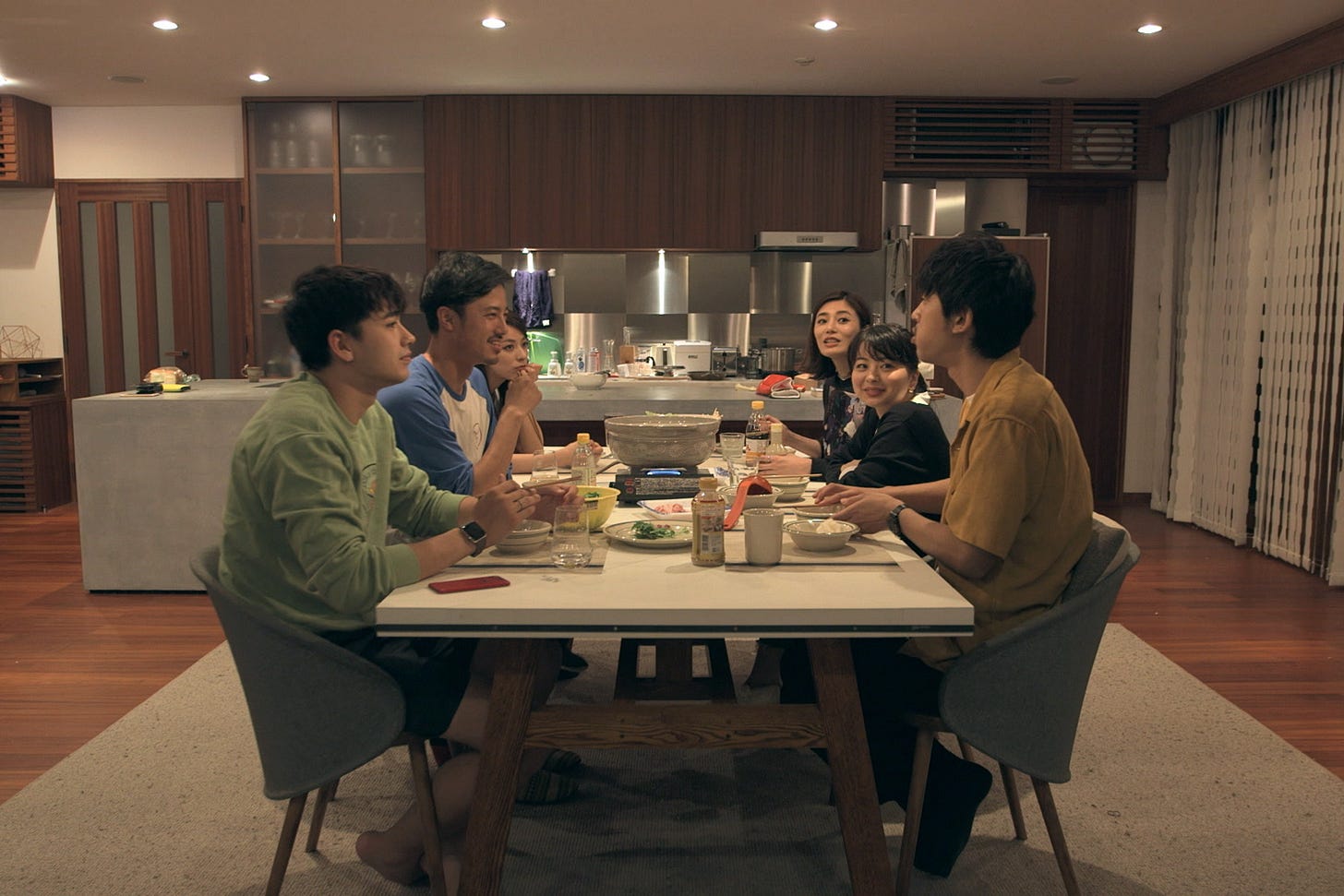 A still from Terrace House with the participants eating dinner together