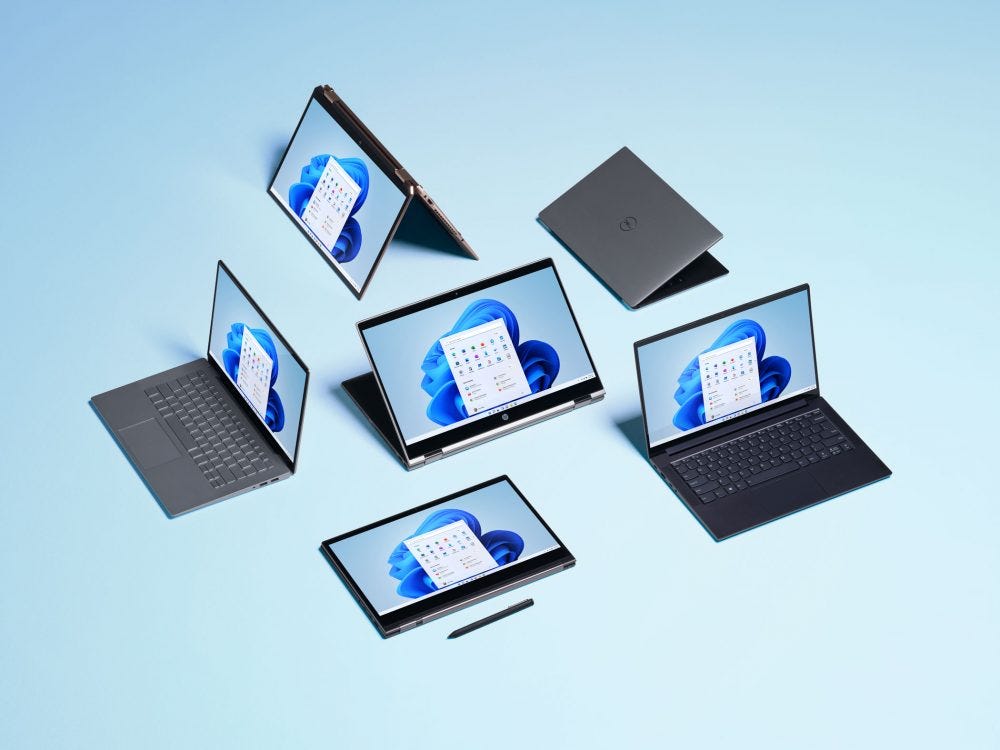 Windows 11 shown on a group of laptops. \(Microsoft\)