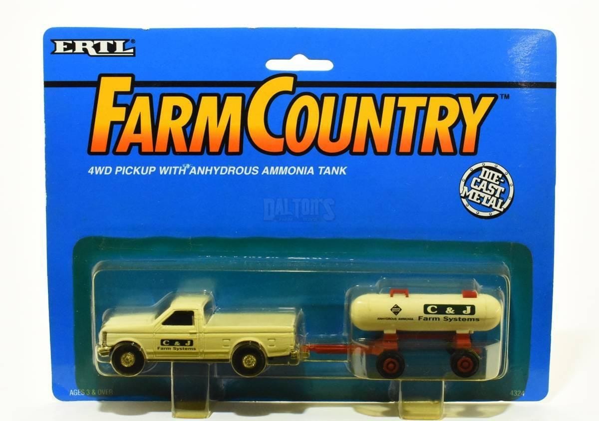 A "Farm Country" branded toy of a four wheel drive pick-up truck hauling a tank of anhydrous ammonia gas