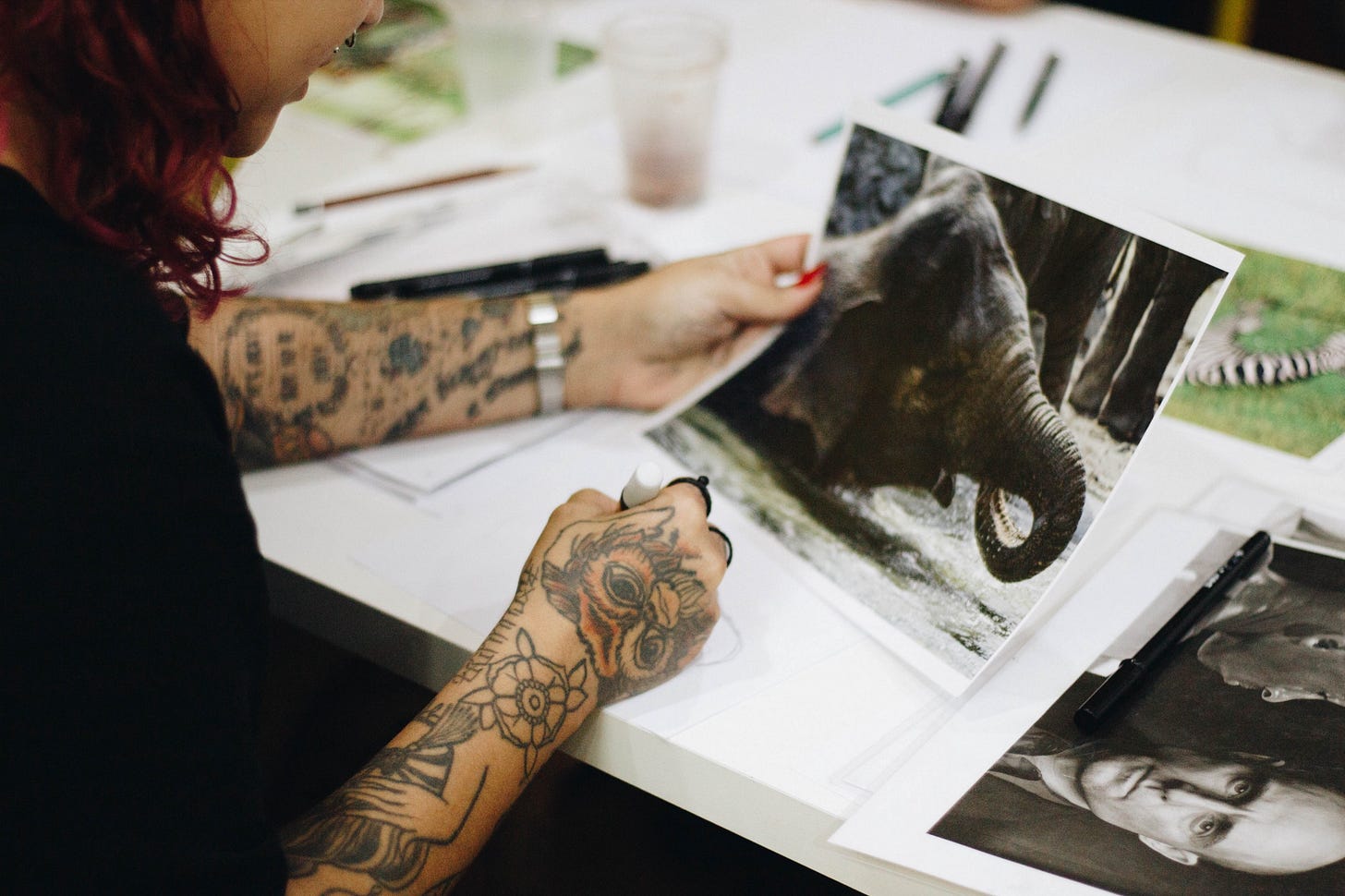 Tattooed lady looking at an elephant photograph for article by Larry G. Maguire Tattooed lady looking at an elephant photograph for article by Larry G. Maguire