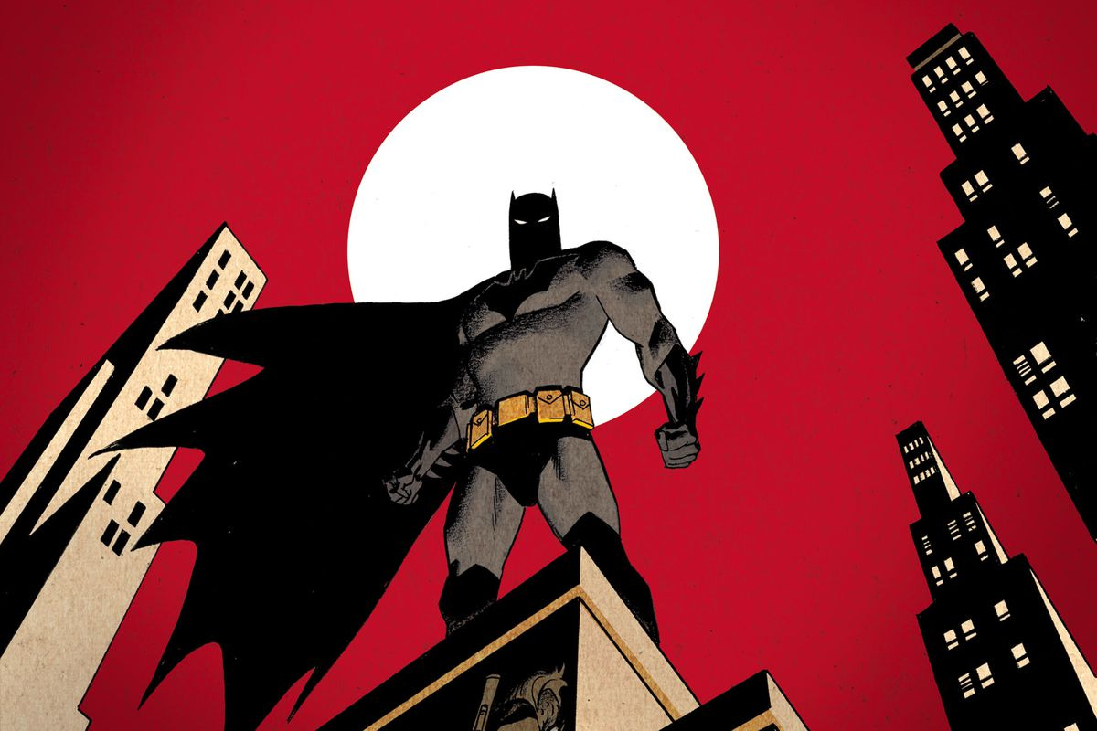 Batman stands on top of a building in Gotham with the faces of his numerous villains in the building below him