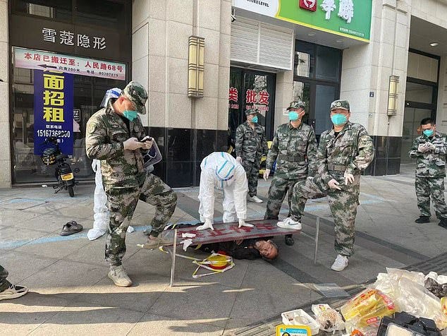 An elderly man in Haining, Zhejiang, around 125km from Shanghai, is pinned to the ground by PPE-clad police for going outside, in breach of Covid restrictions