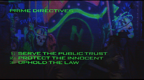 A screenshot from Robocop that reads "Prime Directives: 1.) Serve the public trust. 2.) Protect the innocent 3.) Uphold the law"