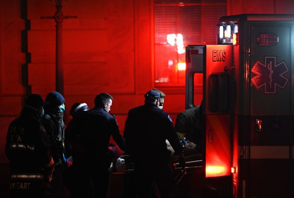 Paramedics perform cardiopulmonary resuscitation on a patient on January 6, 2021, in Washington, DC. - Demonstrators breeched security and entered the US Capitol in Washington, DC, as Congress debated the a 2020 presidential election Electoral Vote Certification. (Photo by ANDREW CABALLERO-REYNOLDS / AFP)