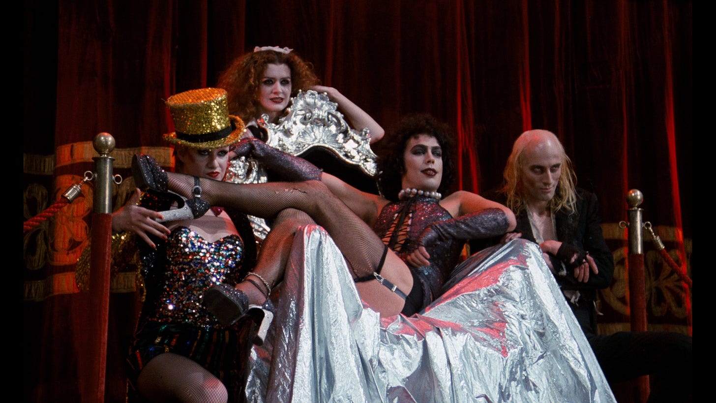 Dr. Frank-N-Furter surrounded by other characters in Rocky Horror Picture Show