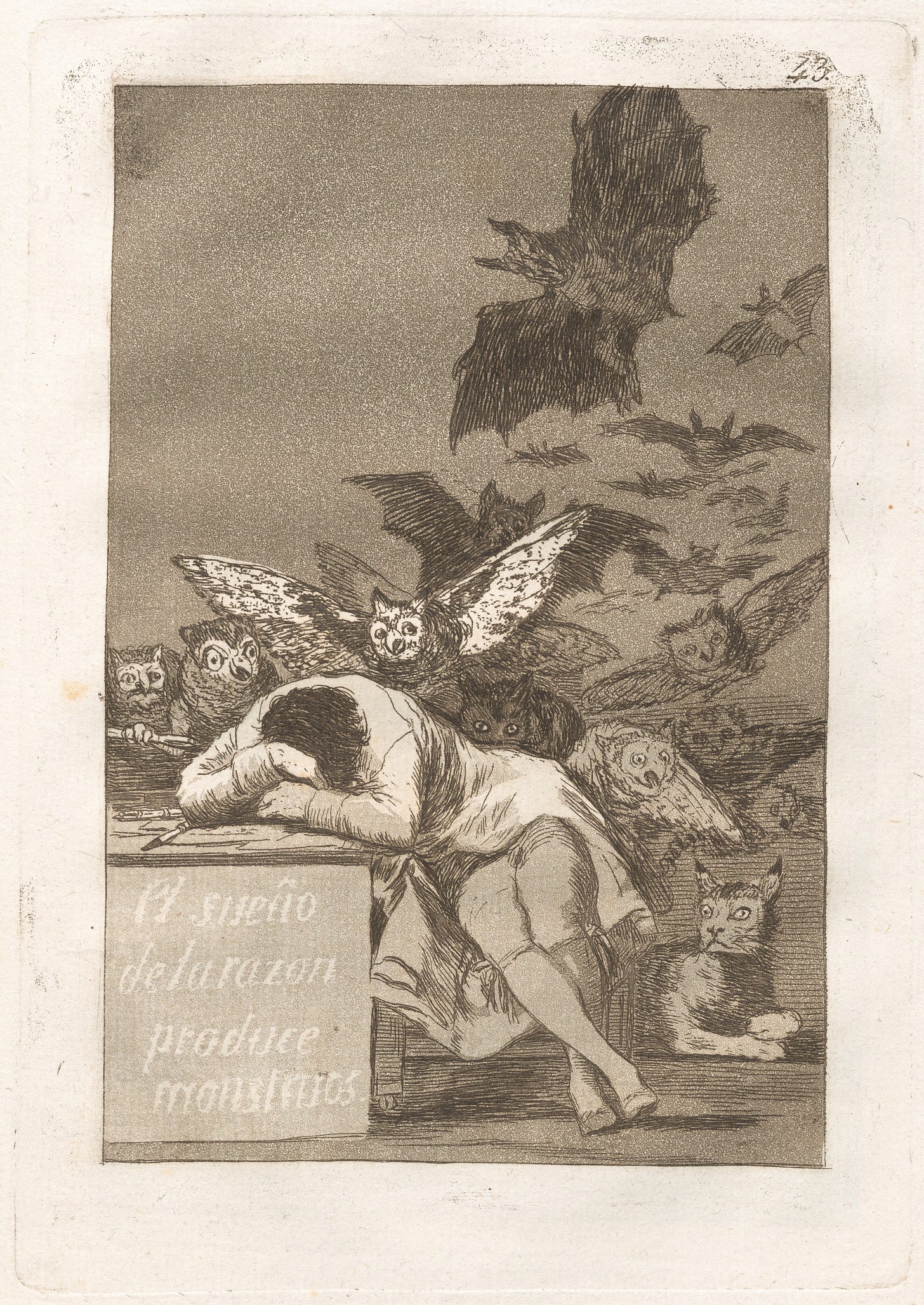 A man sits, his head on his arms against a table which says 'el sueño de la razón produce monstruos'. Above him are frightening winged night creatures and owls diving at him. Behind him sits a big wild cat. It is a sketch.