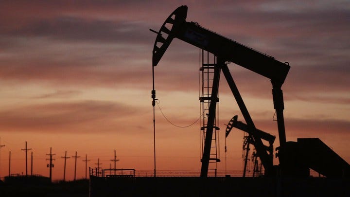 An oil rig silhouetted on a twilight sky An oil rig silhouetted on a twilight sky